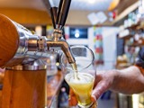 Pouring a beer from a tap close up at a pub