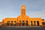 Stone clocktower Council chambers and palm trees
