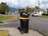 Recycling bin with rubbish bag on top