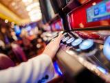Hand on gambling machine
