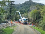 Truck and contractors working on road