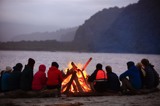 people having bonfire on the beach