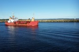 Ship (dredge) approaching river mouth harbour entrance