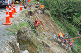 Roading workers working down a roadside bank